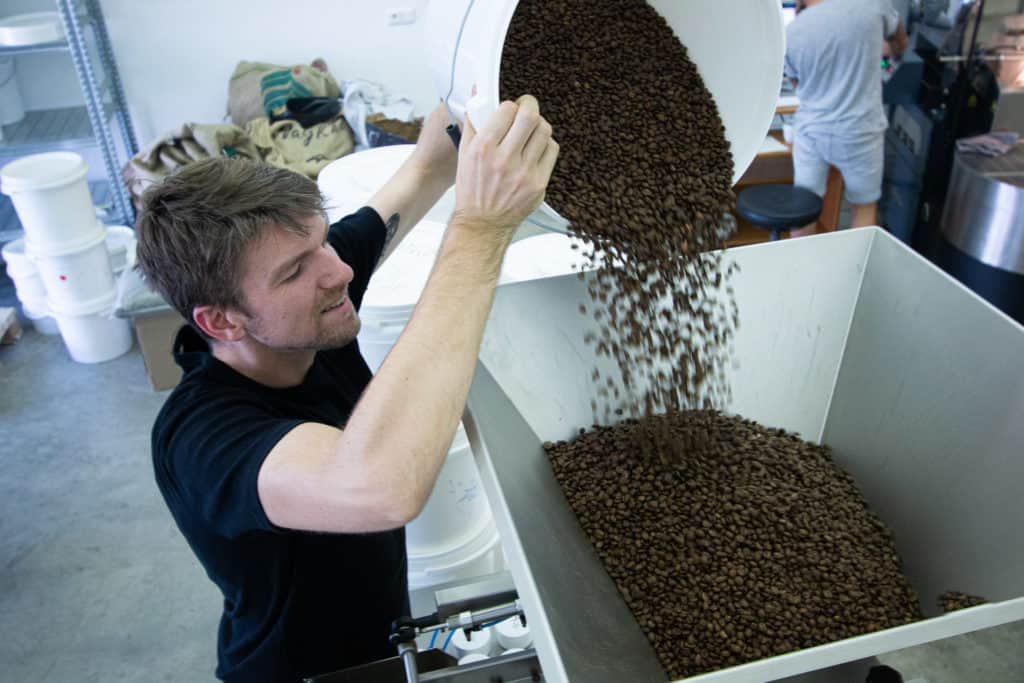Dosing and packaging at Candycane Coffee in Prague.