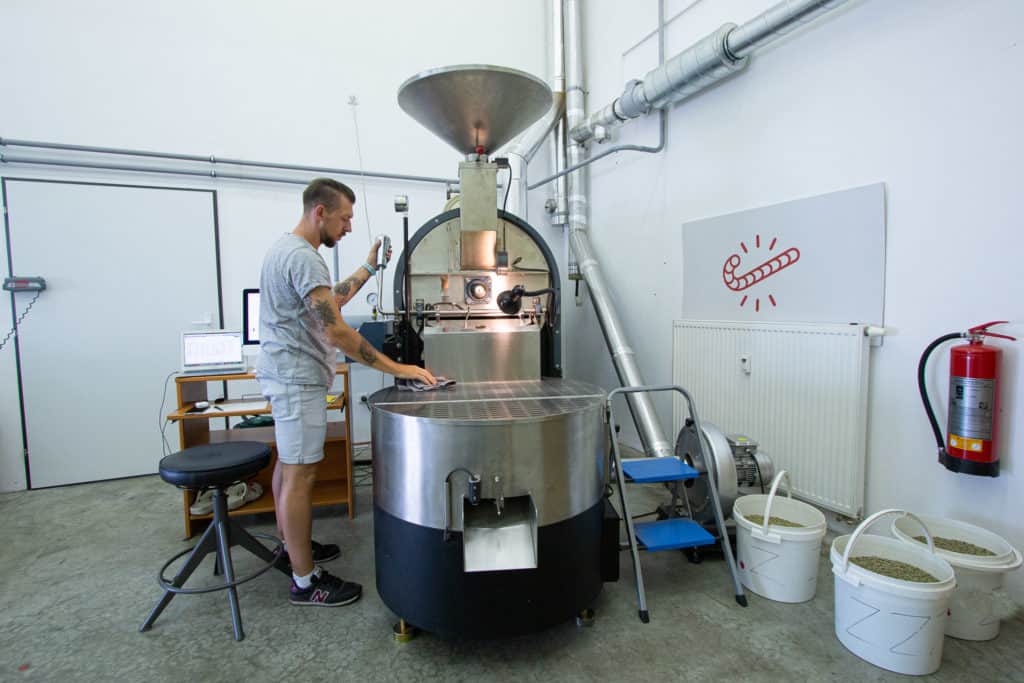 Ondrej Stoksa behind the roasting machine at the Candycane Coffee roastery.